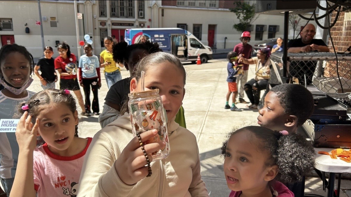 Kids are wowed by a charm at an outdoor fair