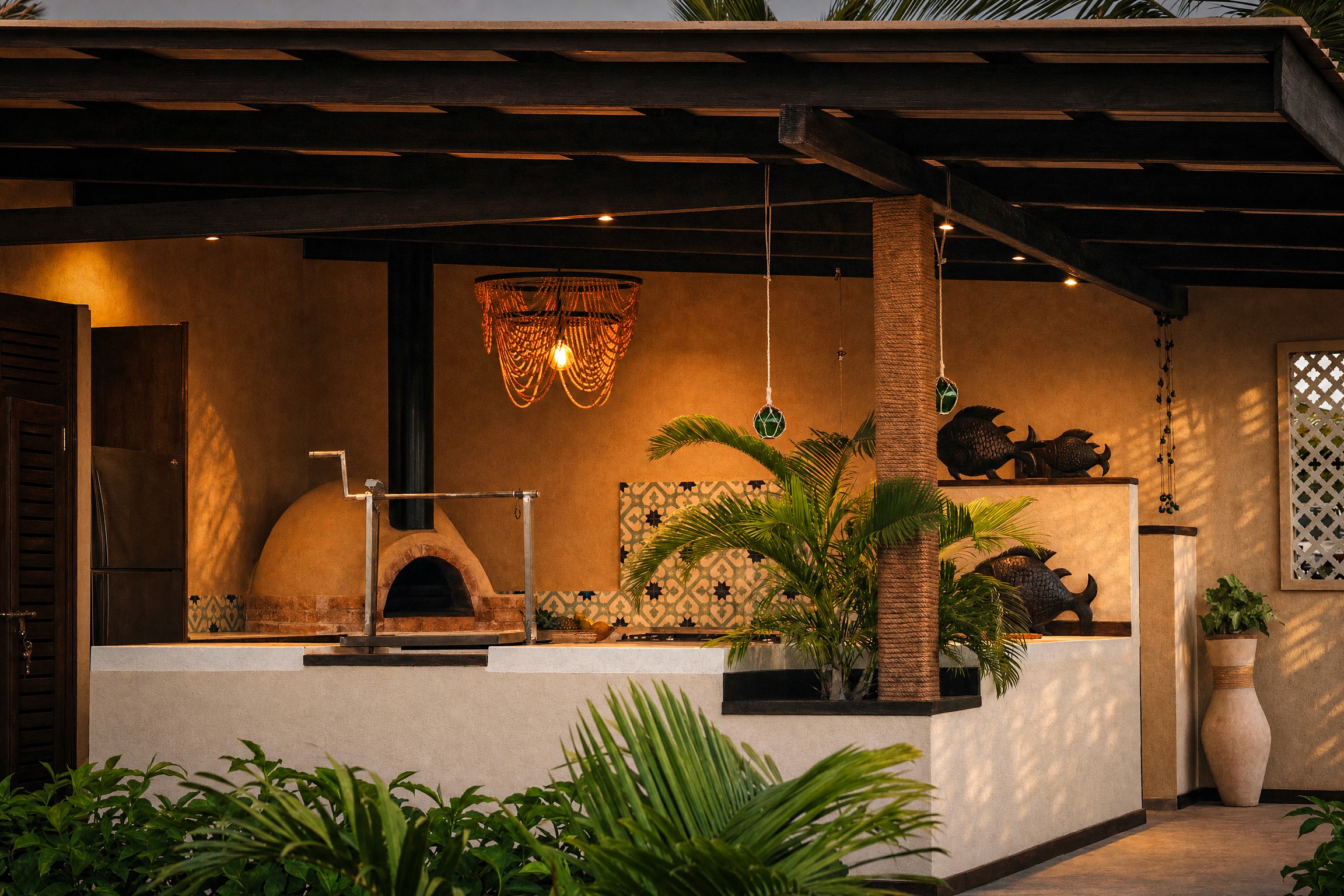 A crackling fire pit glowing at dusk, with a cushioned bench seating area behind it