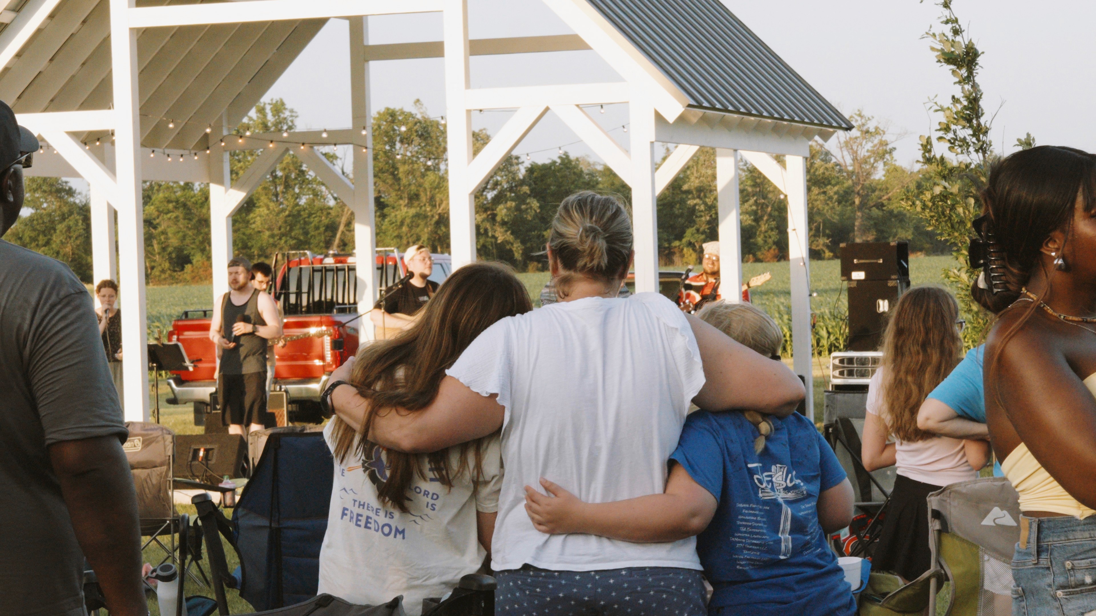People lifting their hands in worship during Worship Night.