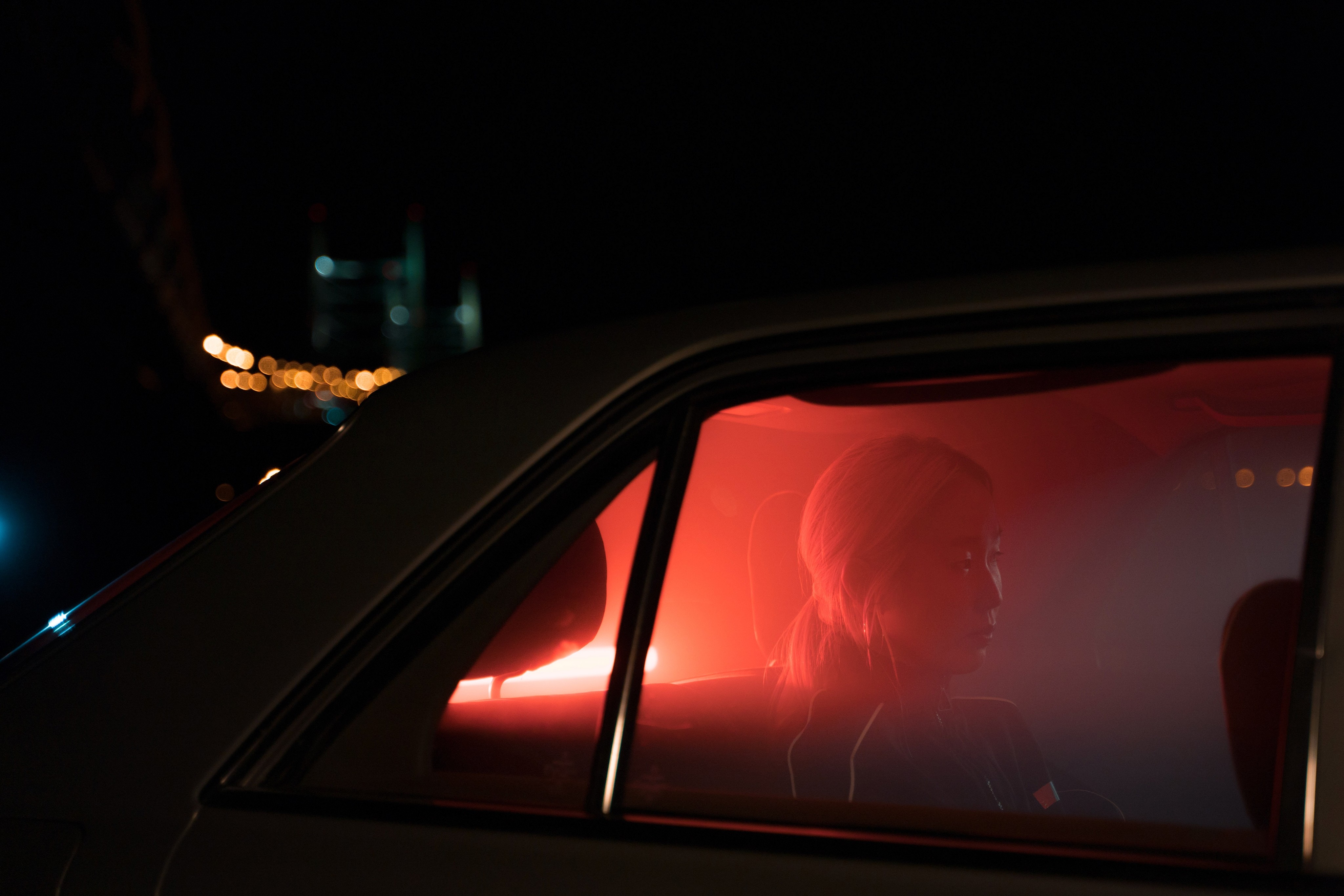 Woman in a car at night in ambient light