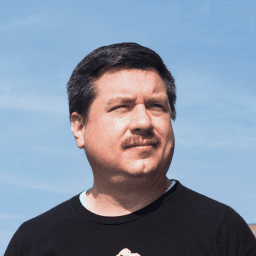 Possible member smiling and looking away from the camera.