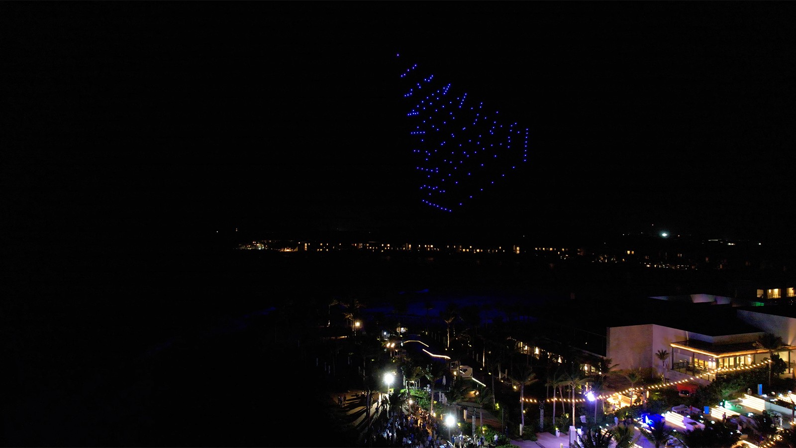 Photo of drones in the shape of a pyramid.