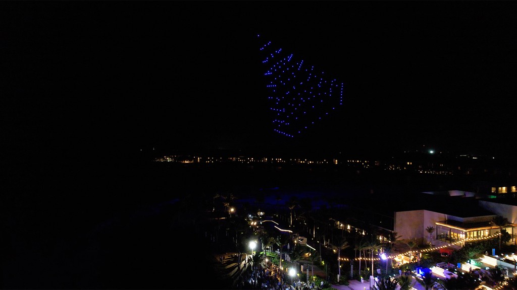 Photo of drones in the shape of a pyramid.