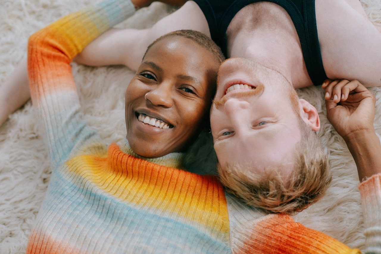 boyfriend and girlfriend lying together smiling