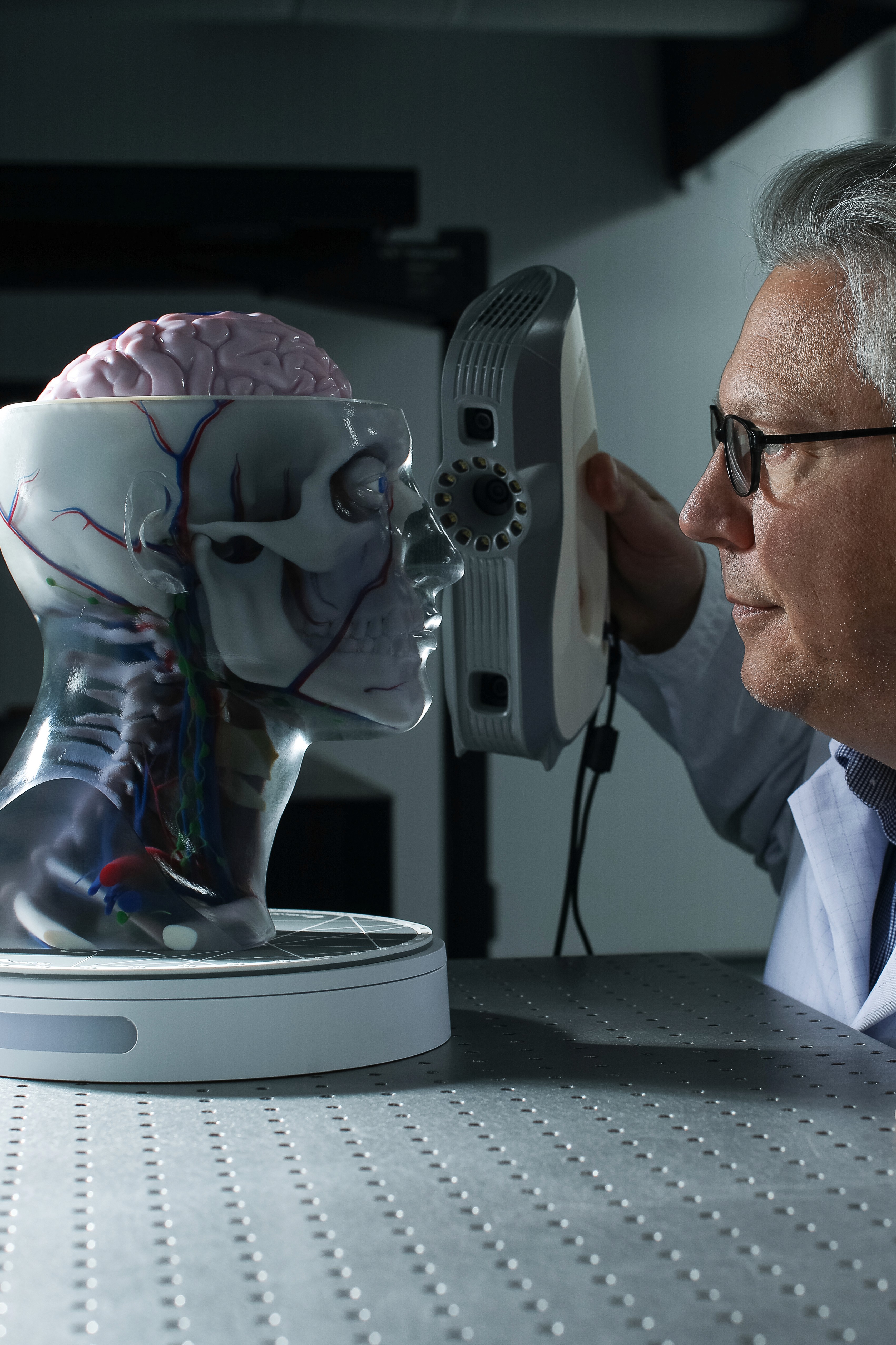 CPI expert examining a fake human head.