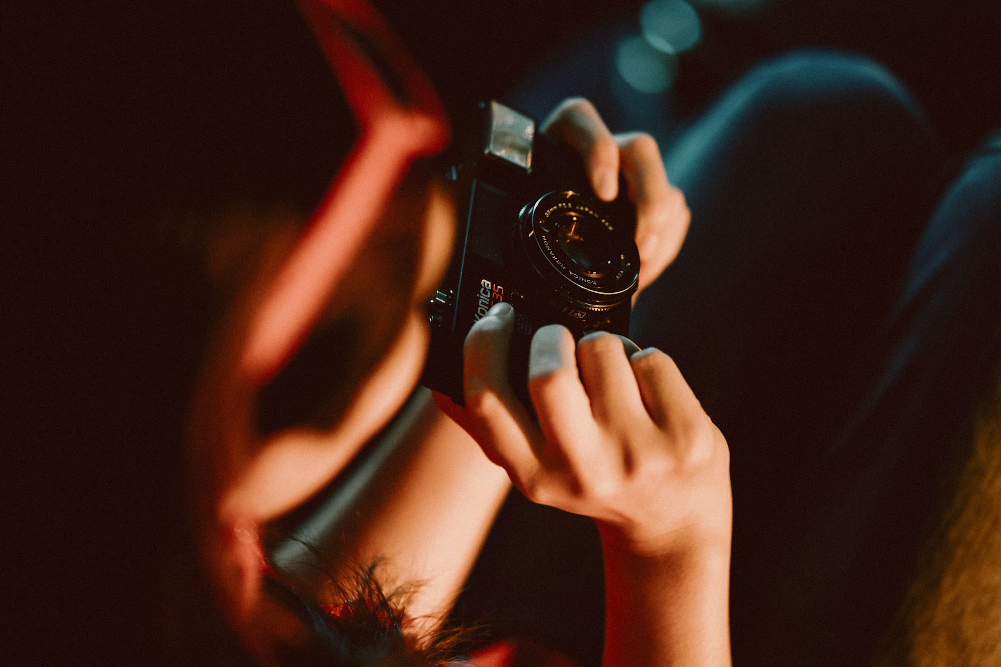 Hands holding a camera in warm light