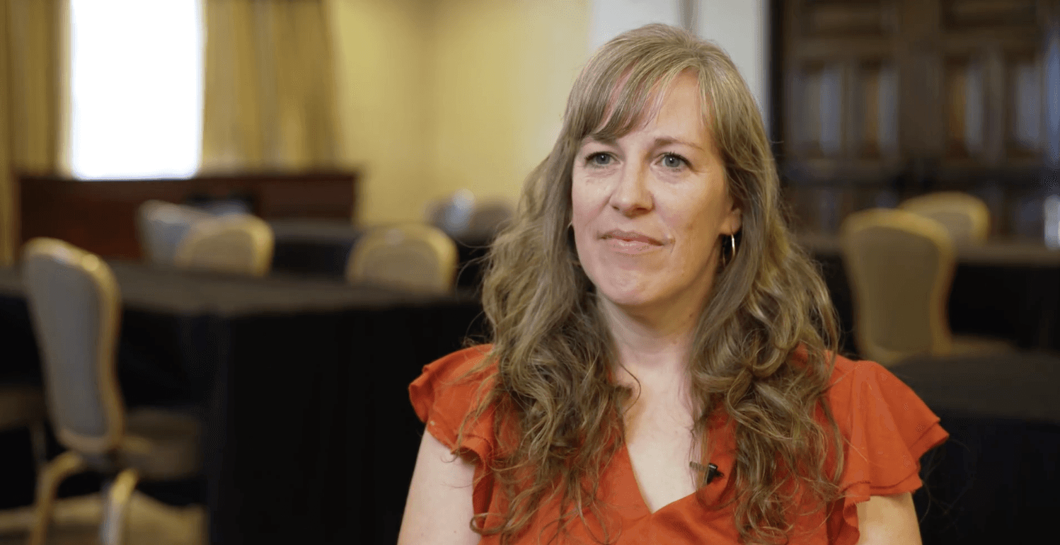 A man standing on top of a skateboard ramp