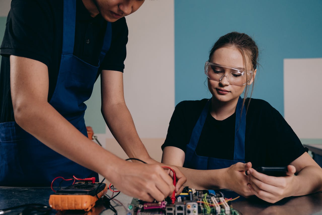 Man and Woman Testing a Motherboard Together