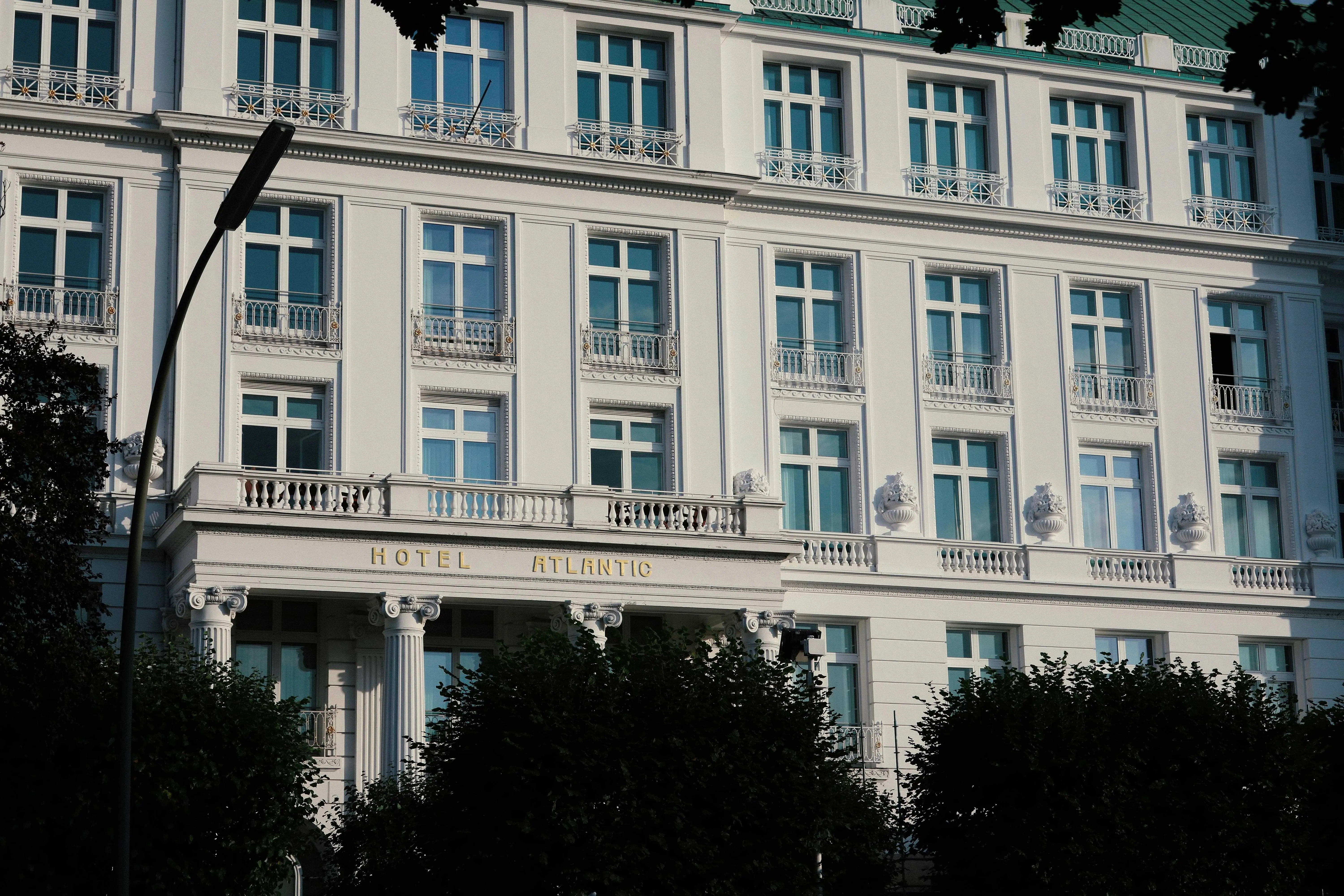 The Waldorf Astoria Hotel towers against a cloudy sky.
