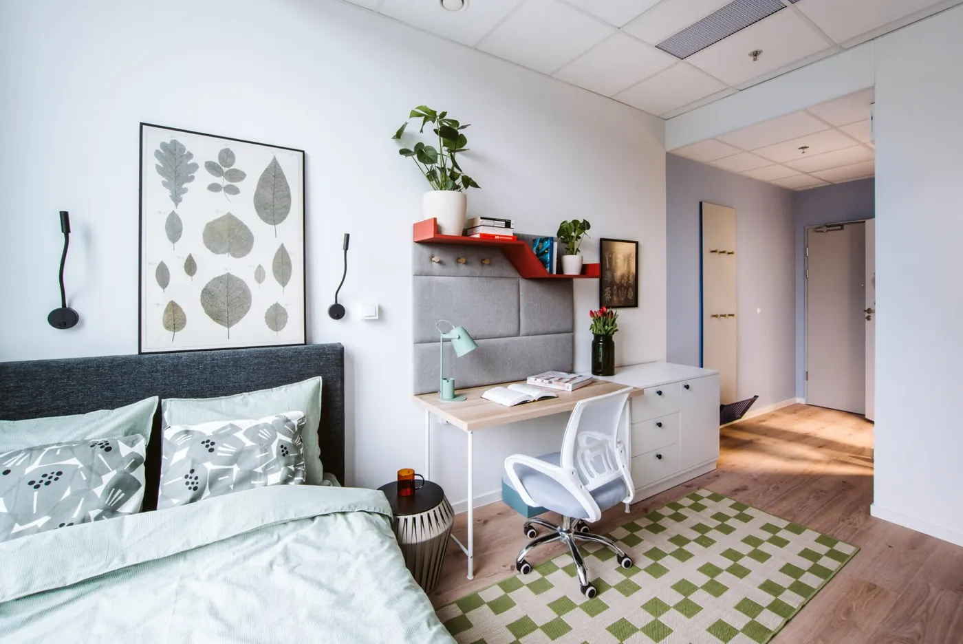 Modern student studio accommodation in Warsaw with bed, study desk and private kitchenette