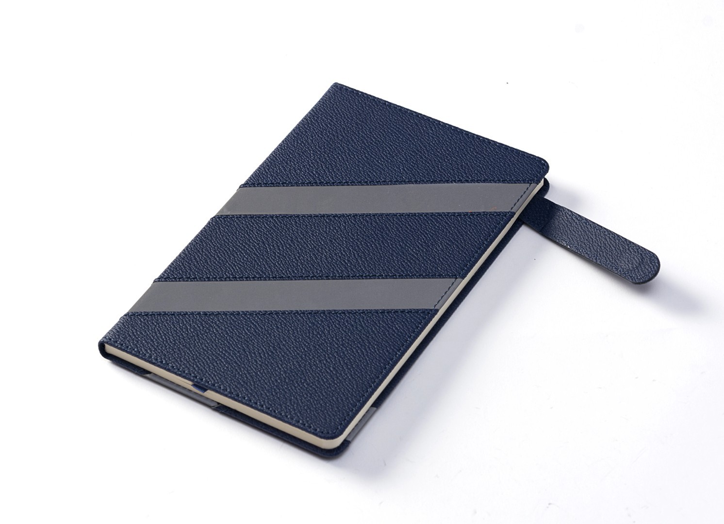 Angled view of blue notebook with open magnetic strap.