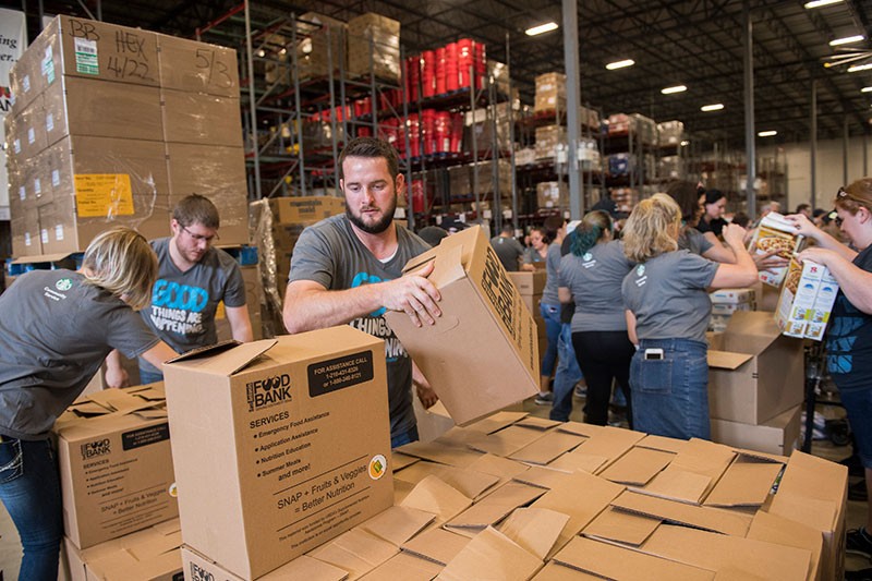 people serving and moving boxes