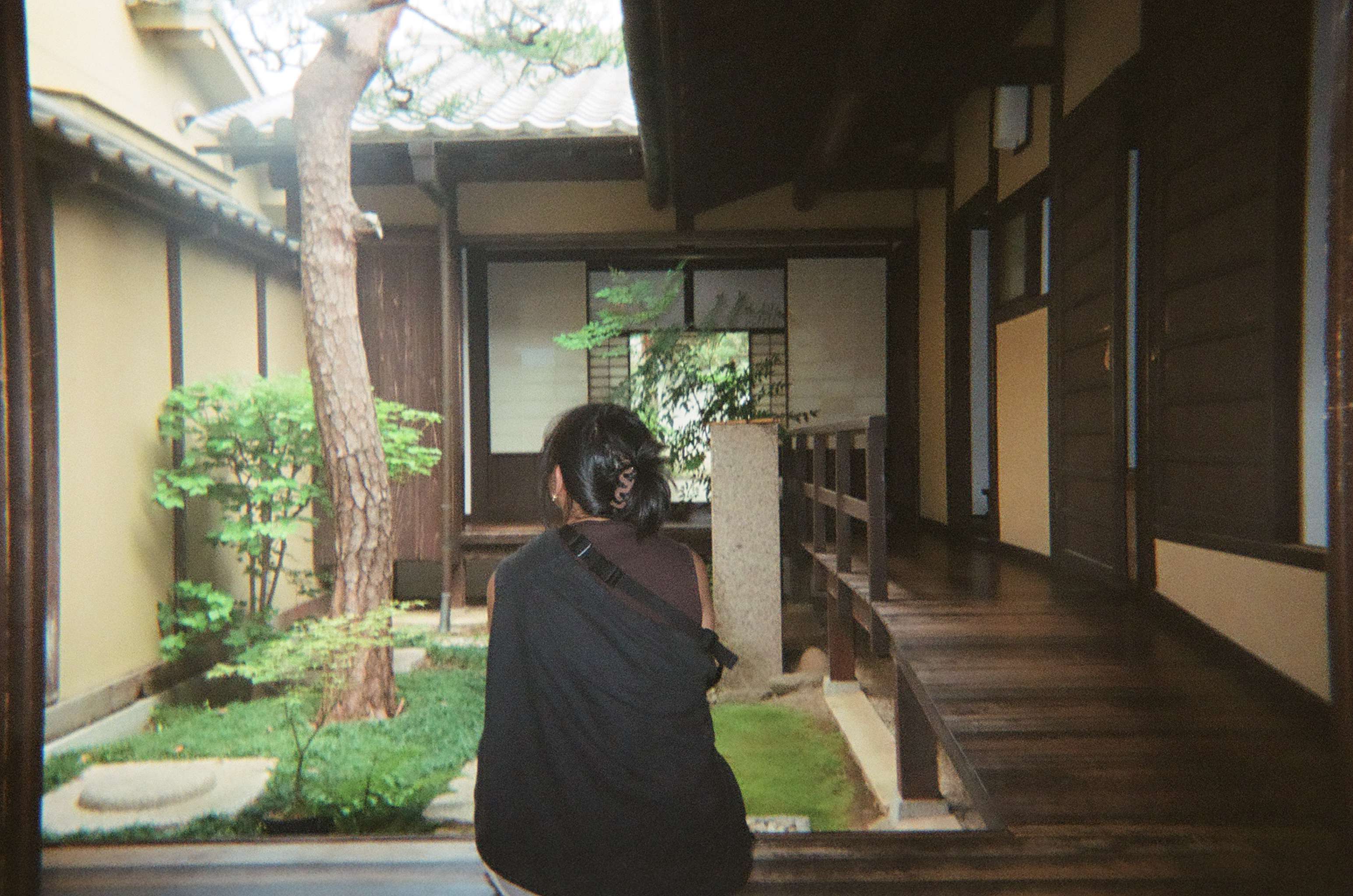 Film photograph of Jeanelle sitting in Kyoto Craft House, Japan