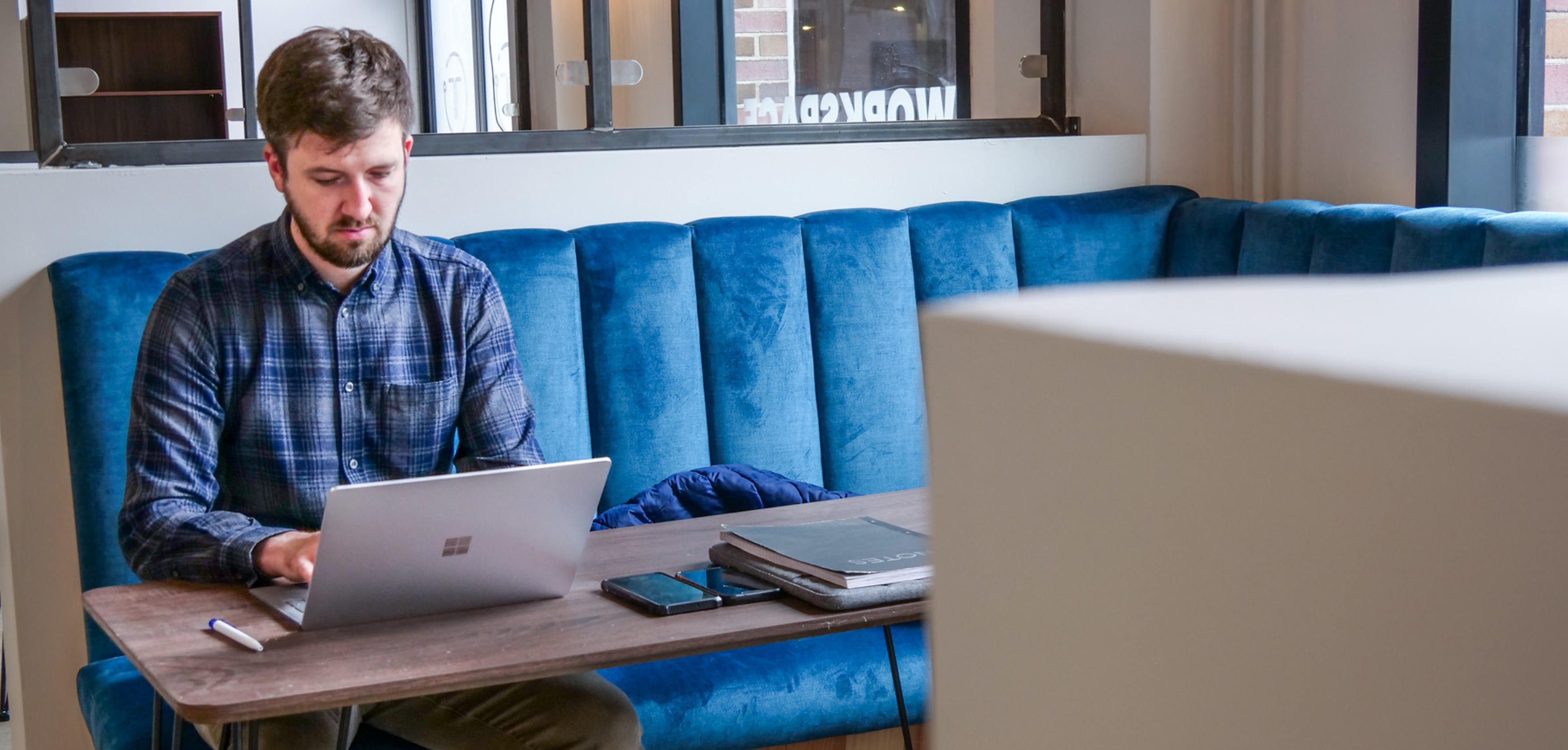 A person using a laptop at an office.