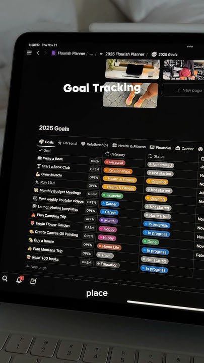 A man with long hair is working on a computer.