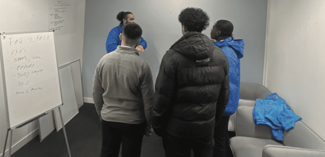 A businesswoman sitting at her desk, smiling and looking at the camera.