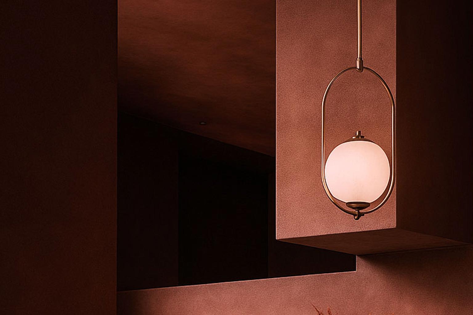 Warm dining nook with brown walls, modern pendant light, round table, green chairs, and dried pampas grass.