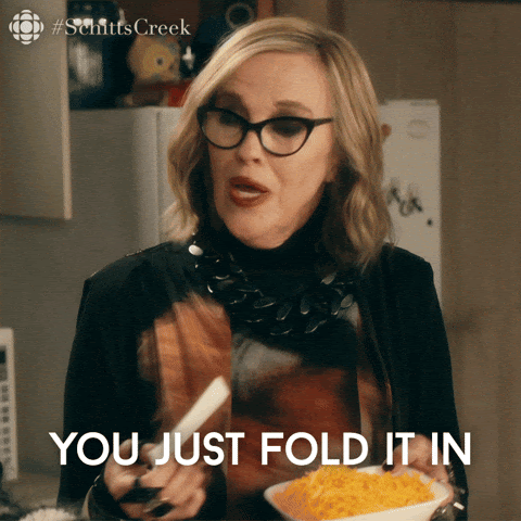gif of Catherine O'Hara saying "just fold it in" while holding a bowl of cheese