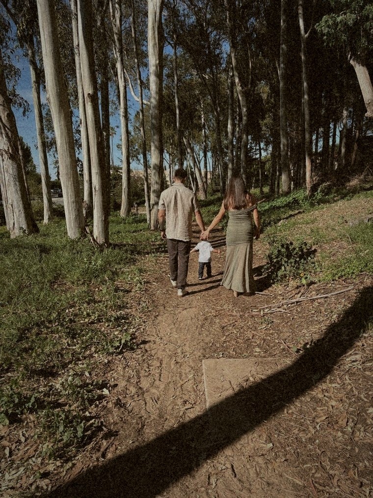 Tony walking a shaded trail with his family
