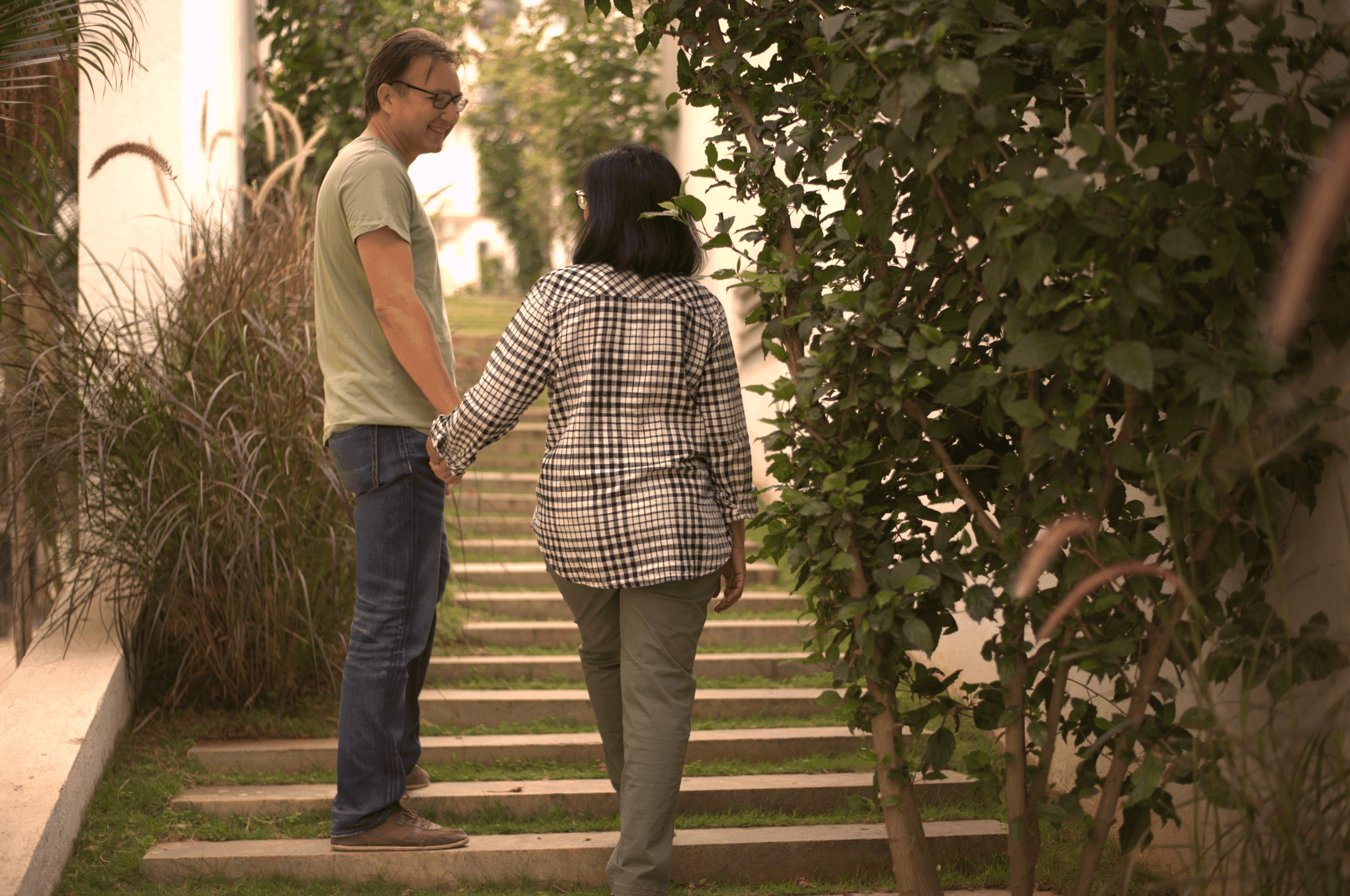 A couple in formal wedding attire embraces intimately in a vast.