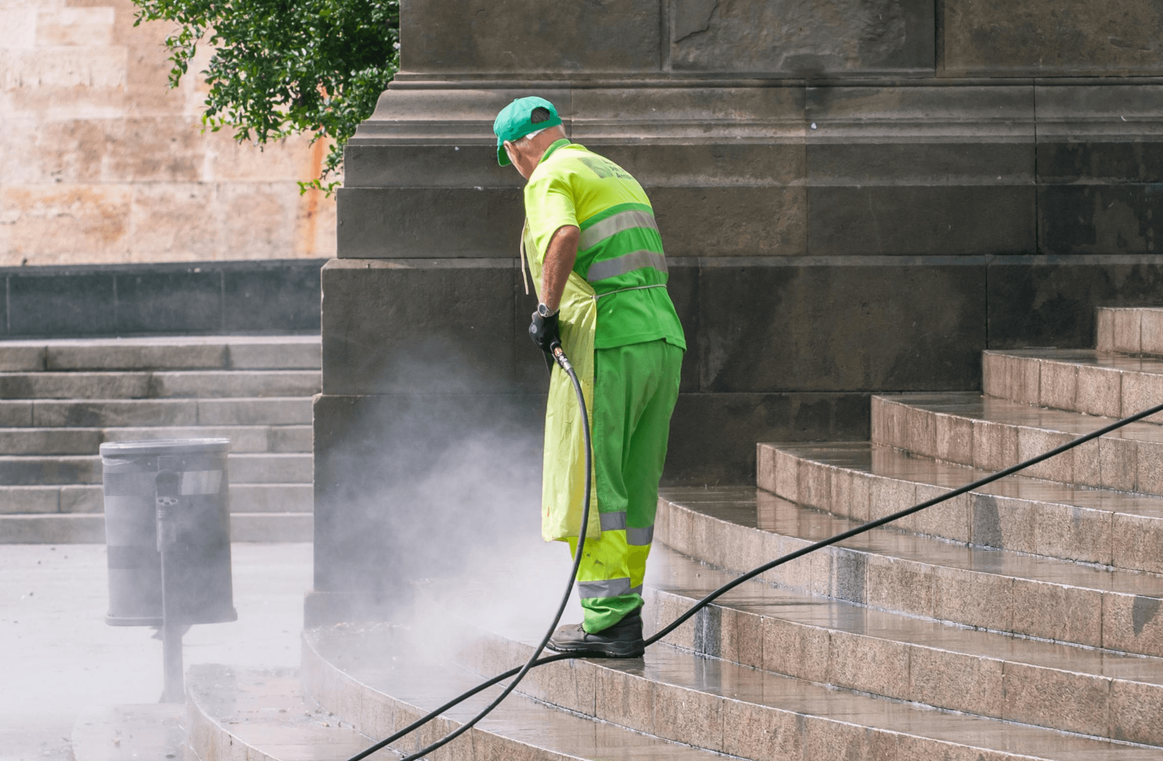 Commercial pressure washing in progress outside high street retail unit