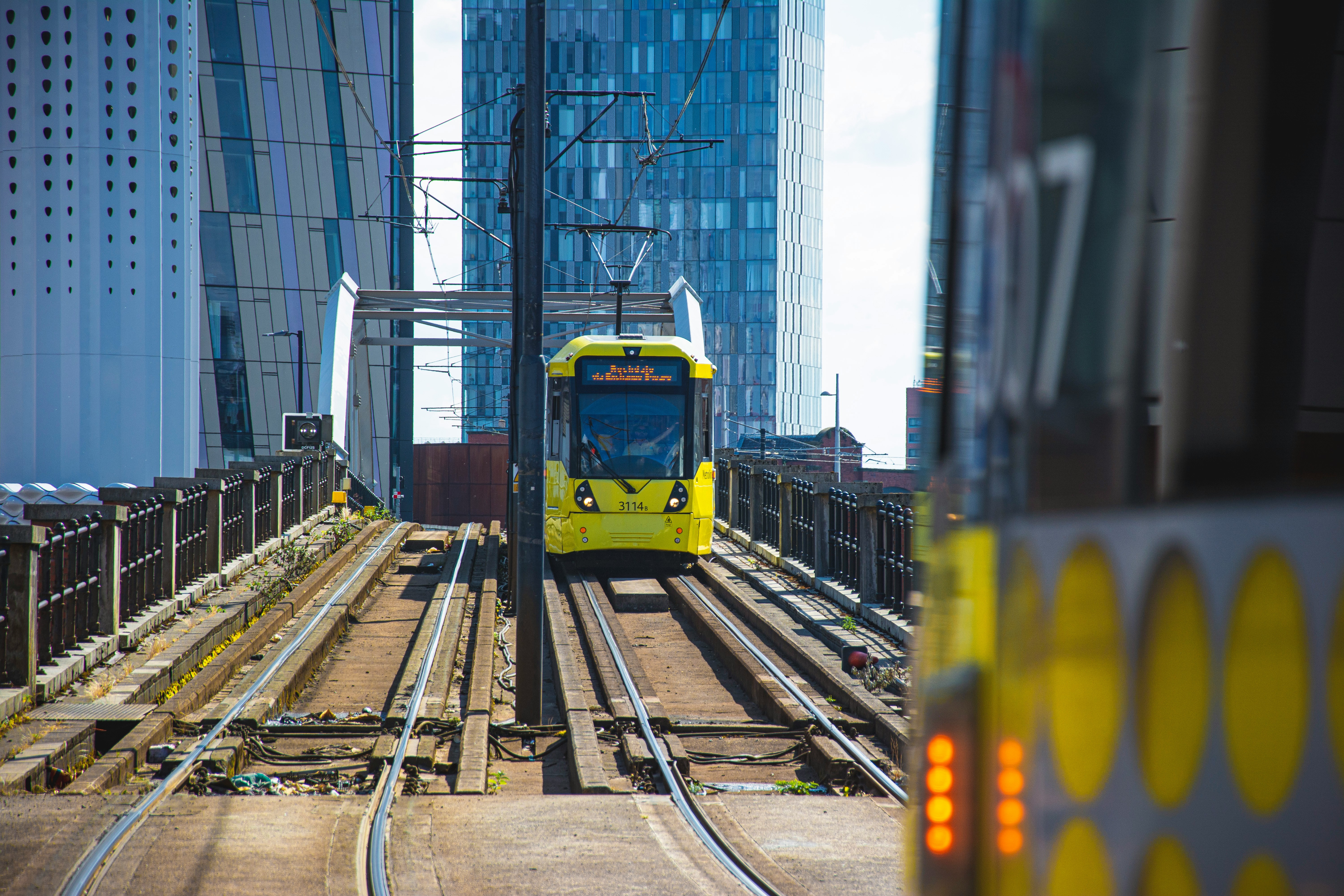 yellow and white train on rail tracks