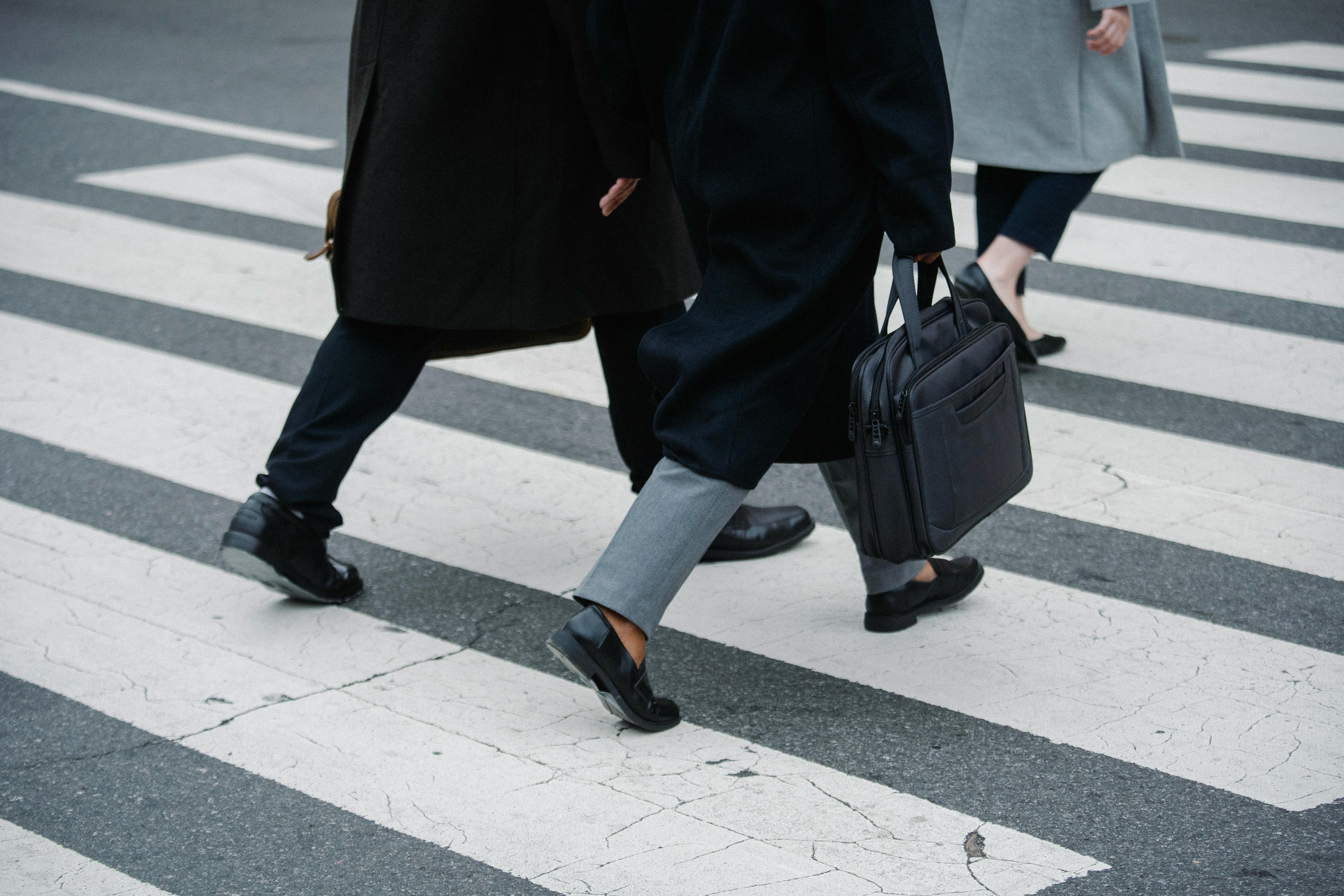 Business people walking across a zebra crossing