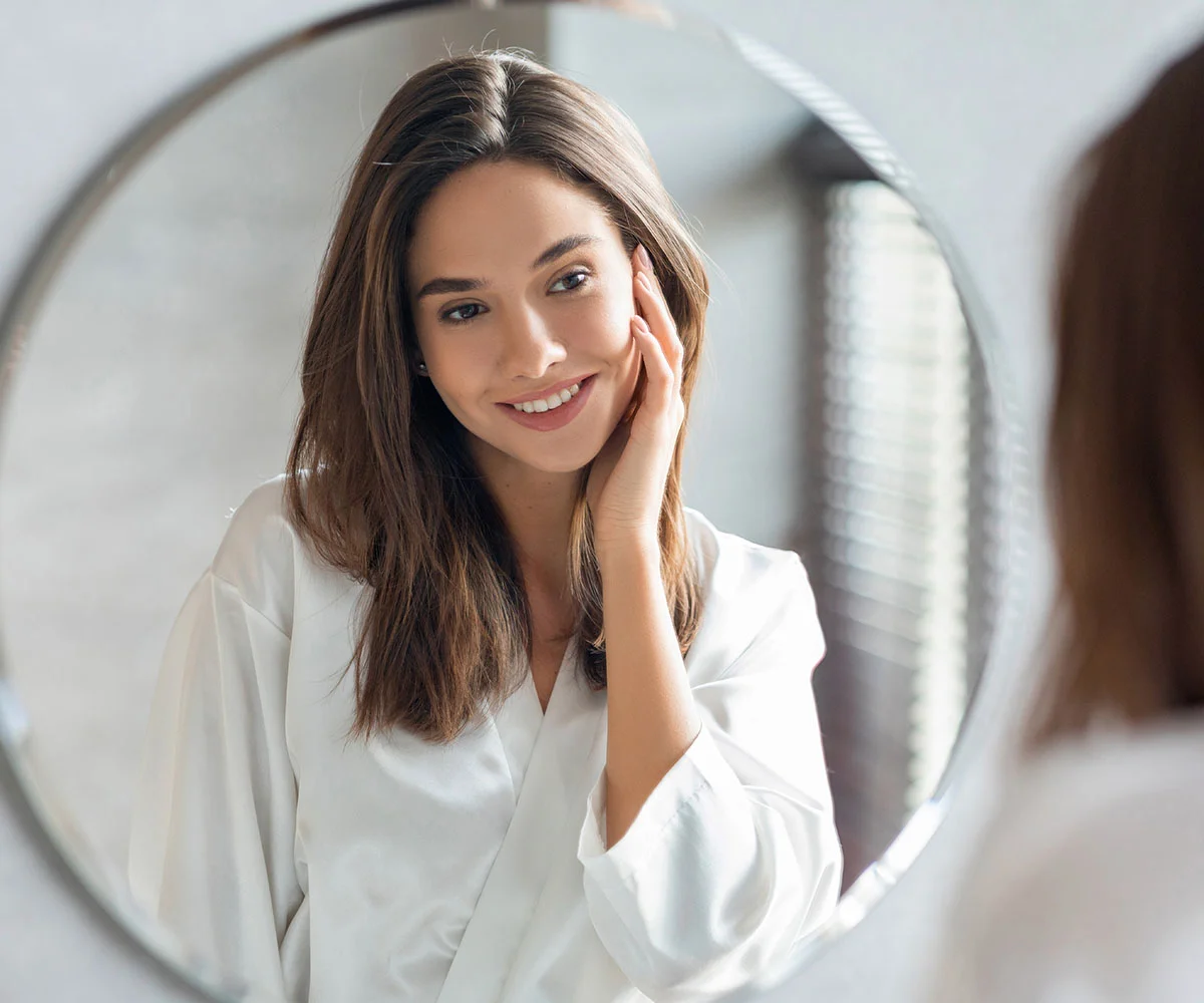 Woman experiencing wisdom tooth pain and facial discomfort representing common symptoms that may require wisdom tooth removal treatment in Fresno, CA.