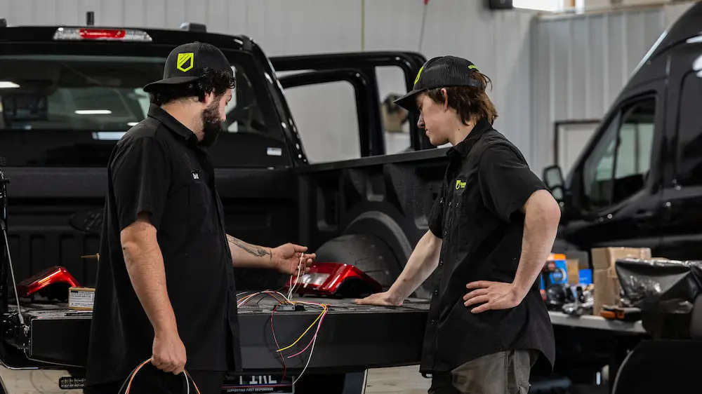 Guardian Fleet Safety technicians reviewing wiring and equipment during a police vehicle upfit