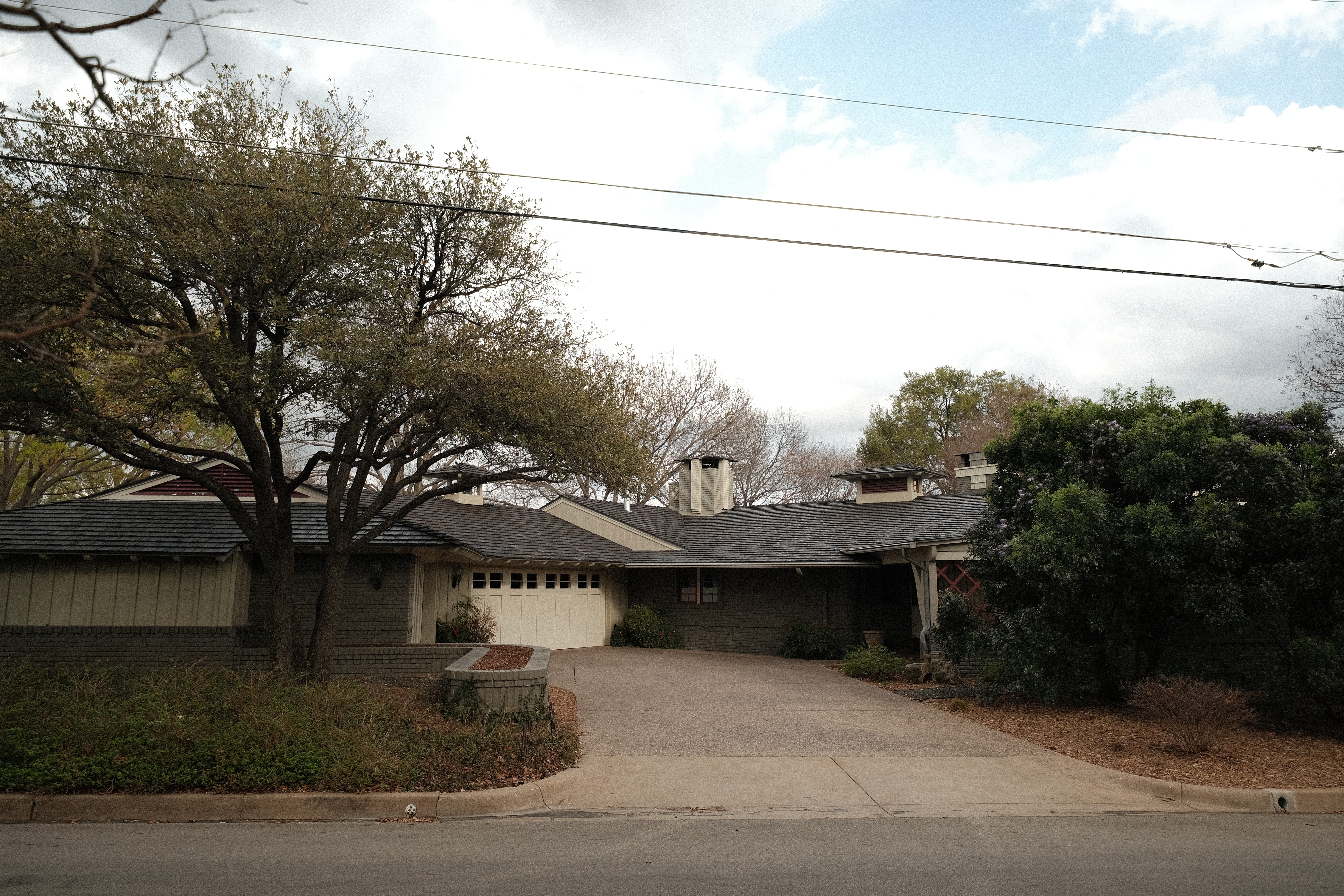 Aerial of a Kessler Park midcentury ranch home in Oak Cliff with a new Brava synthetic shake roof in dark charcoal