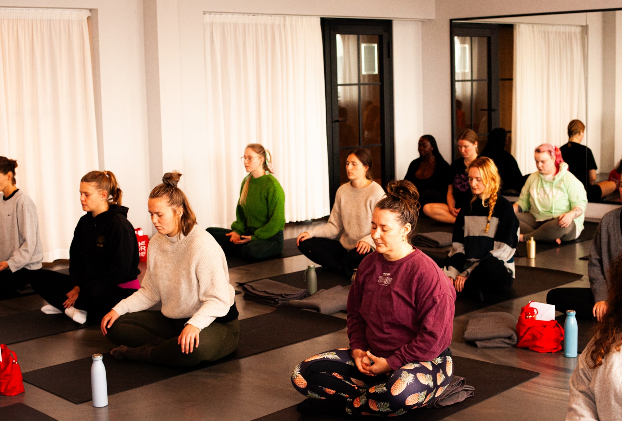 Women practicing yoga during a workshop.