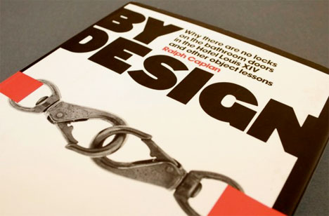 A cover of a design book with some orange straps on it.
