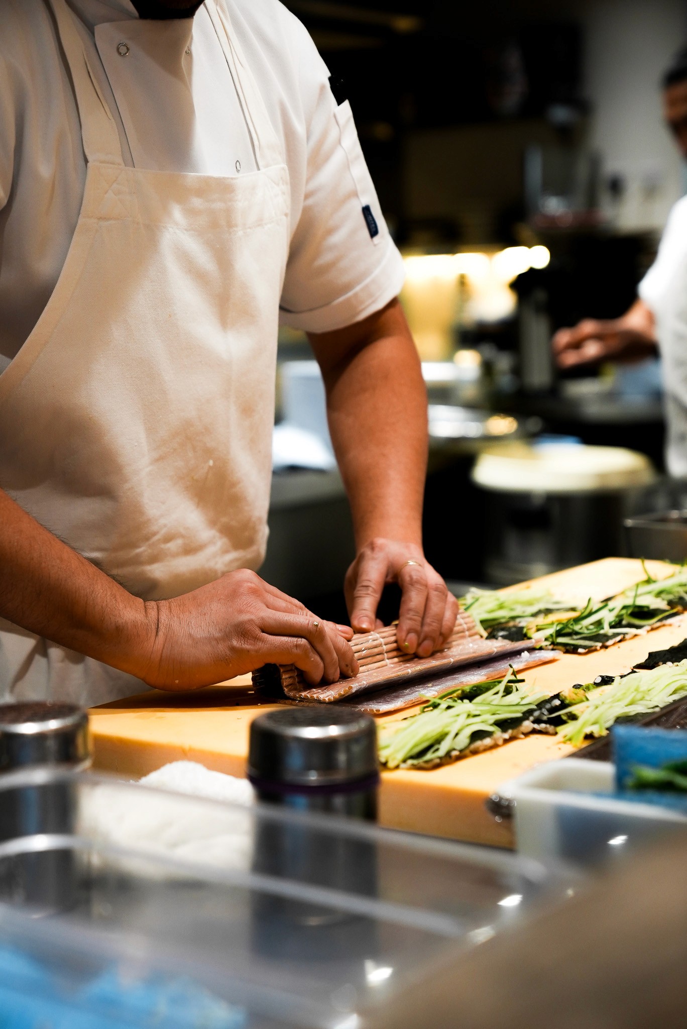 Close-up of bride and groom's torsos, bride in white dress