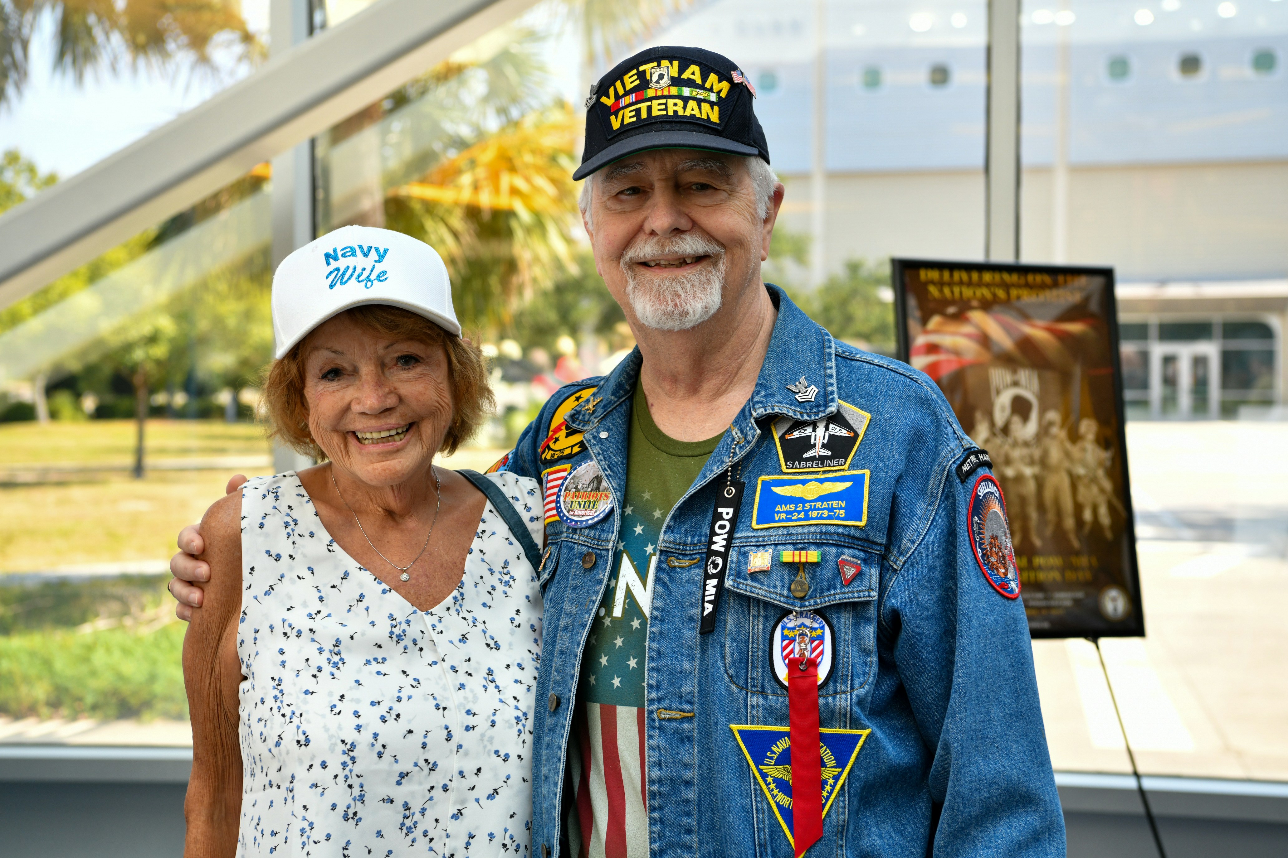 A veteran and his wife smiling and posing together.