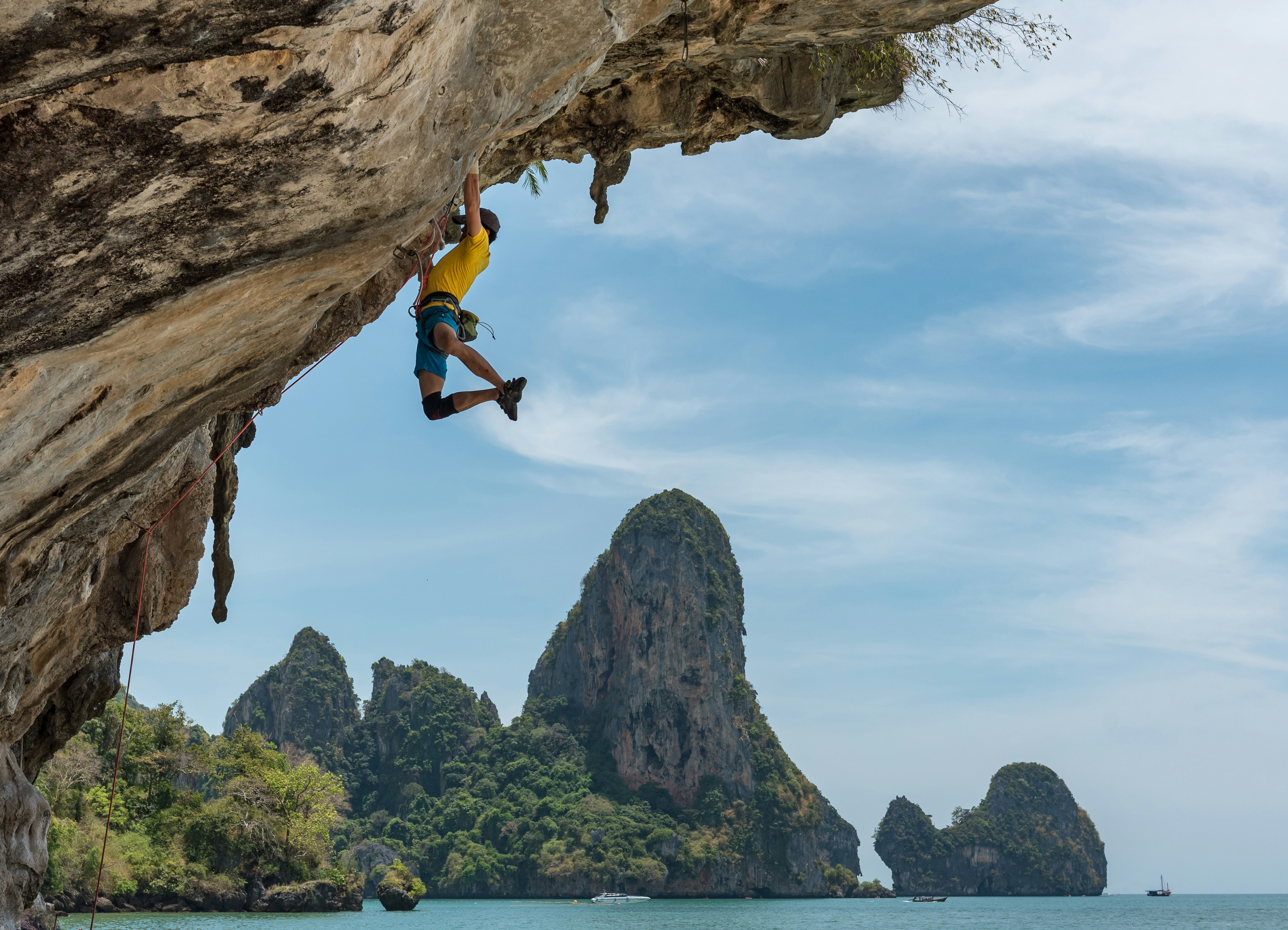 person climbing a rockface
