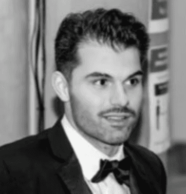 A man works on a laptop in an office.