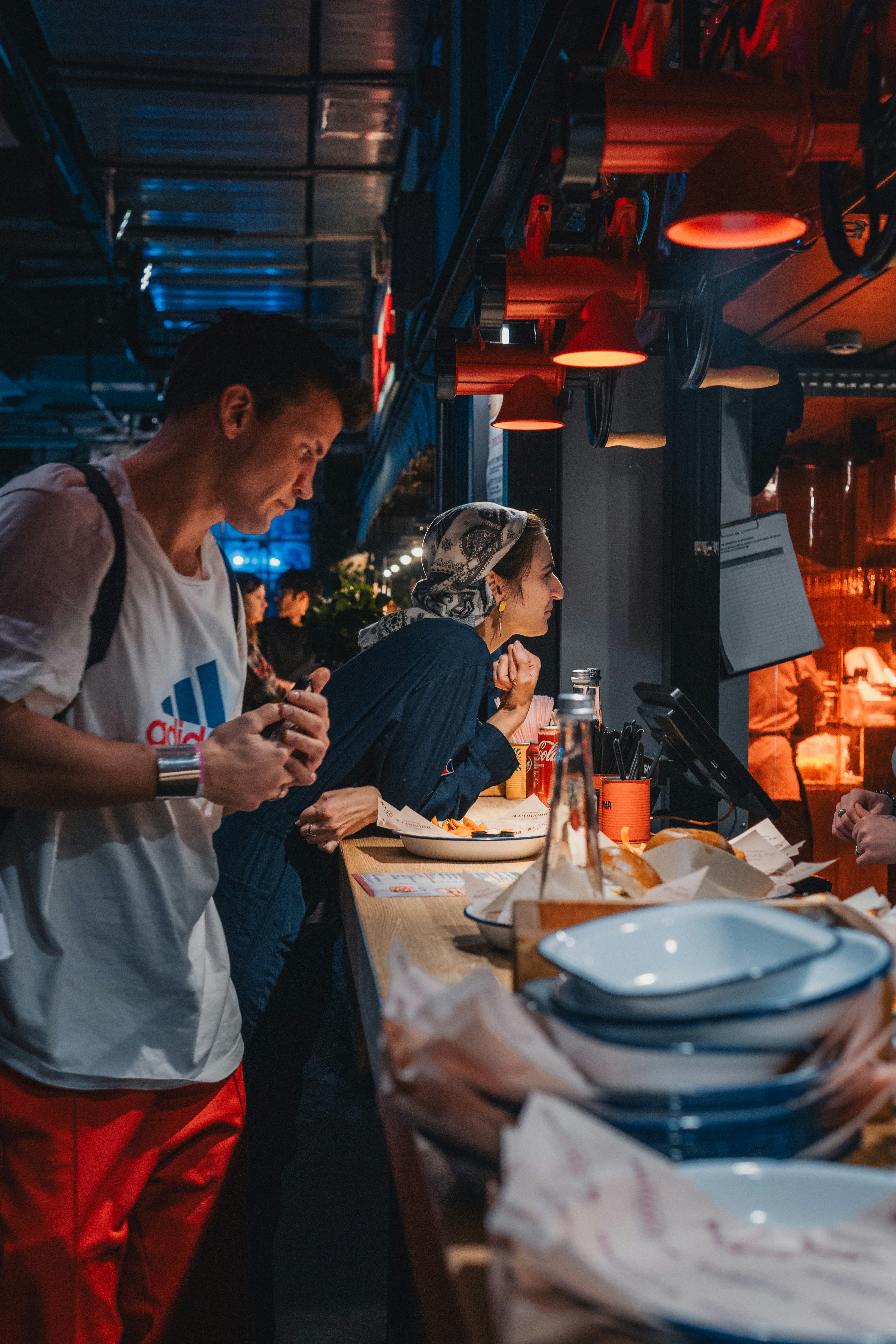 People order food at a busy bar.