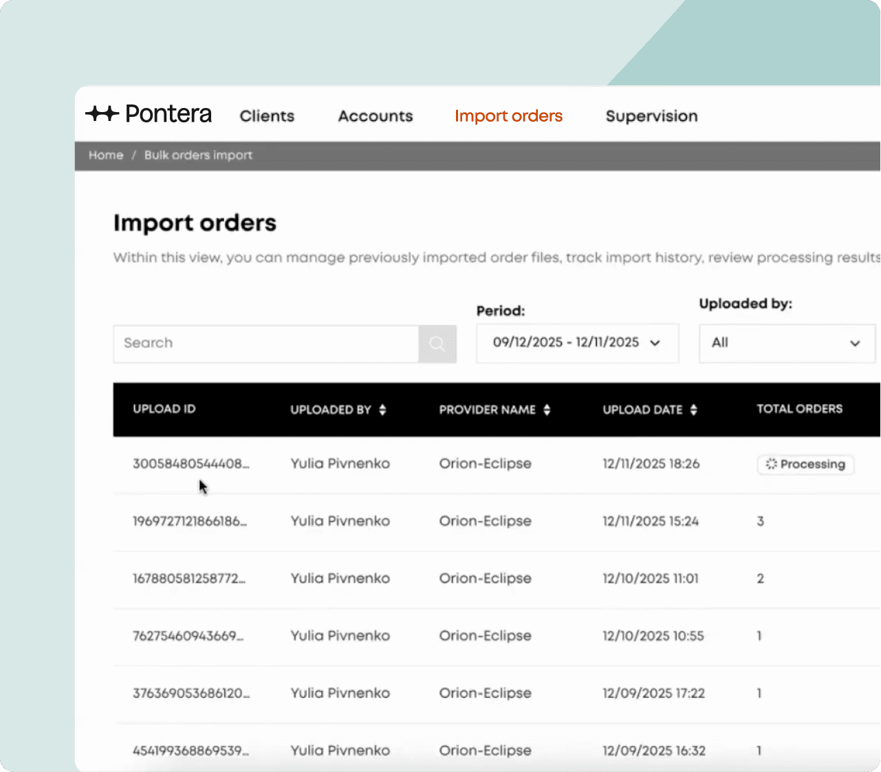 A retiree smiles by a sunlit window, holding a sheer curtain, wearing yellow glasses and a floral jacket