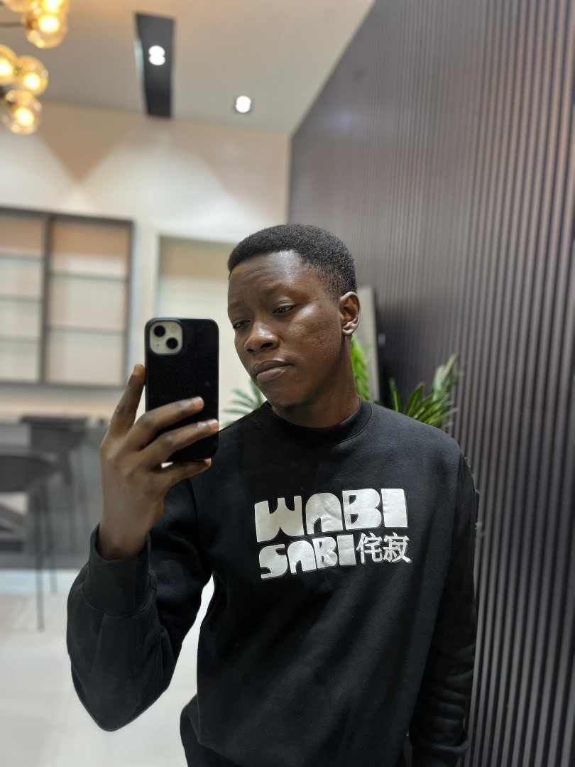 Man dressed in denim jacket pressing laptop