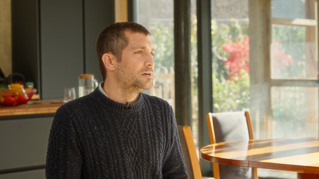 Close up of an man being interviewed in a modern living room