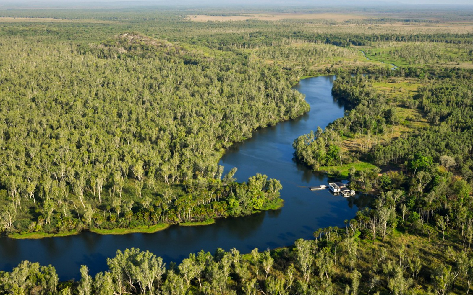 Aerial view of Finniss River surrounded by lush greenery on the Top End Safari Camp Day Tour from Darwin.