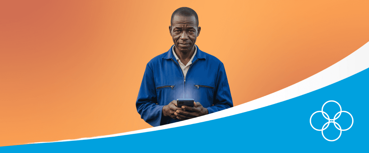 African poultry farmer in a blue overall, holding a phone