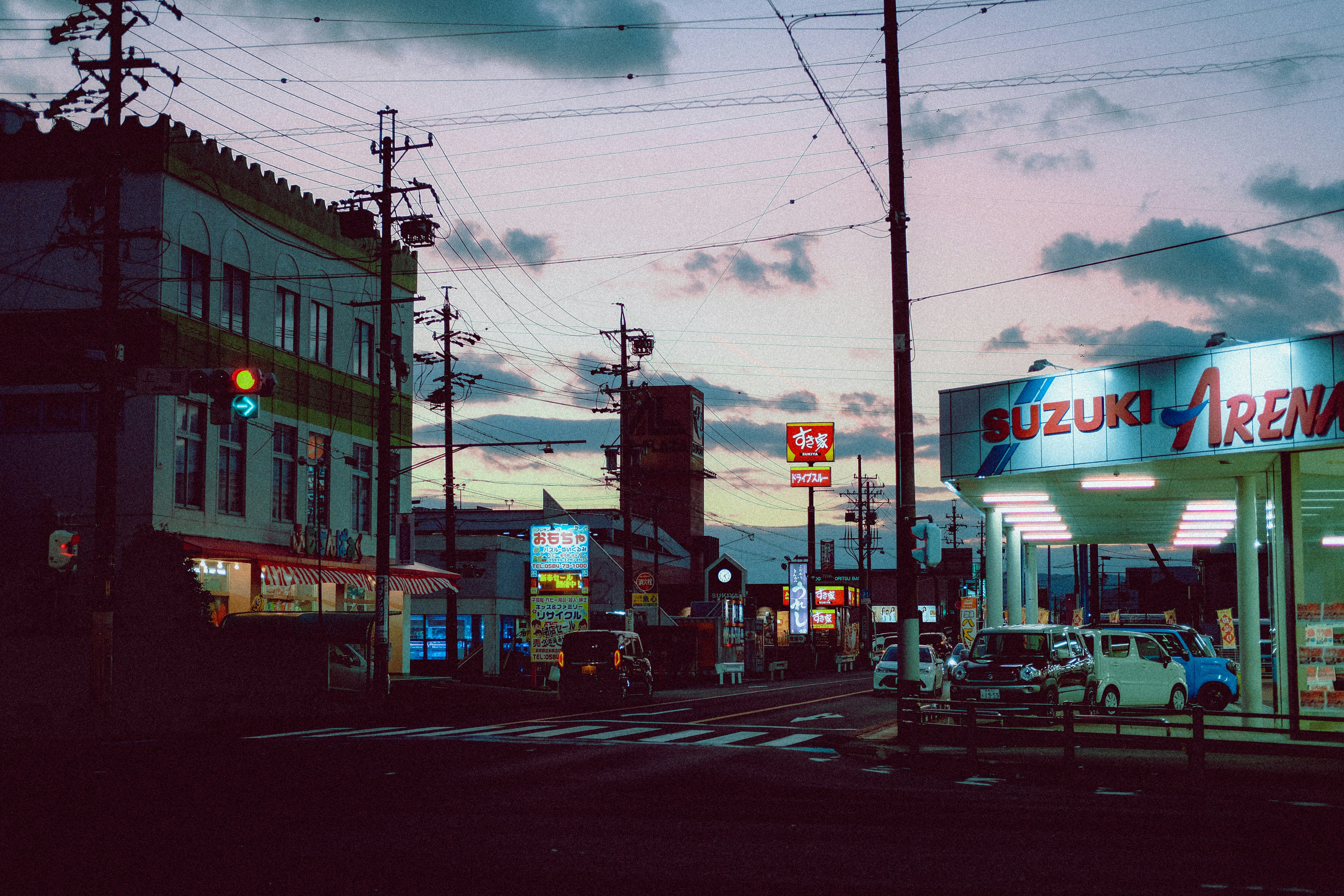 cars parked in front of store during night time