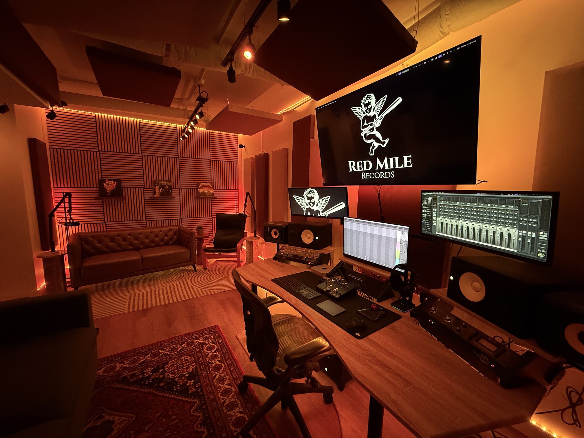 High-end music production equipment, dual monitors, and custom PC setup at Red Mile Records Calgary.