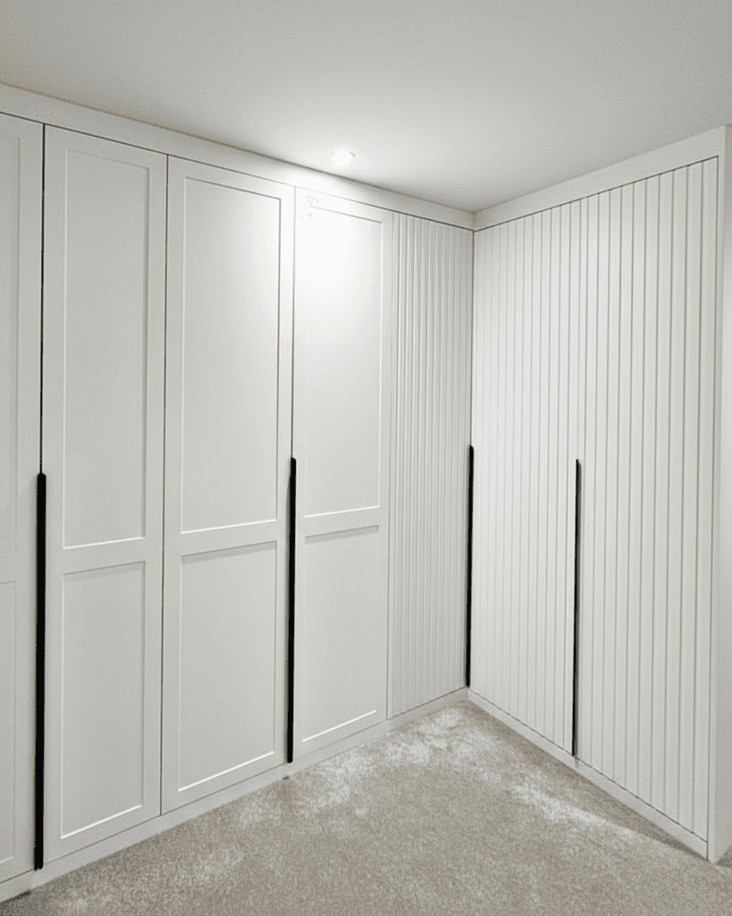 white wardrobe in room with blue pattern wall
