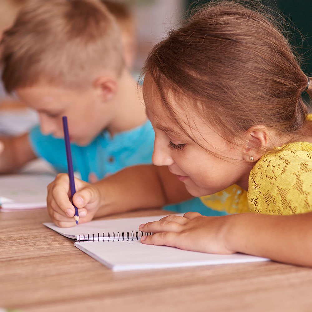 Students developing storytelling and creative writing skills in after school literacy enrichment program