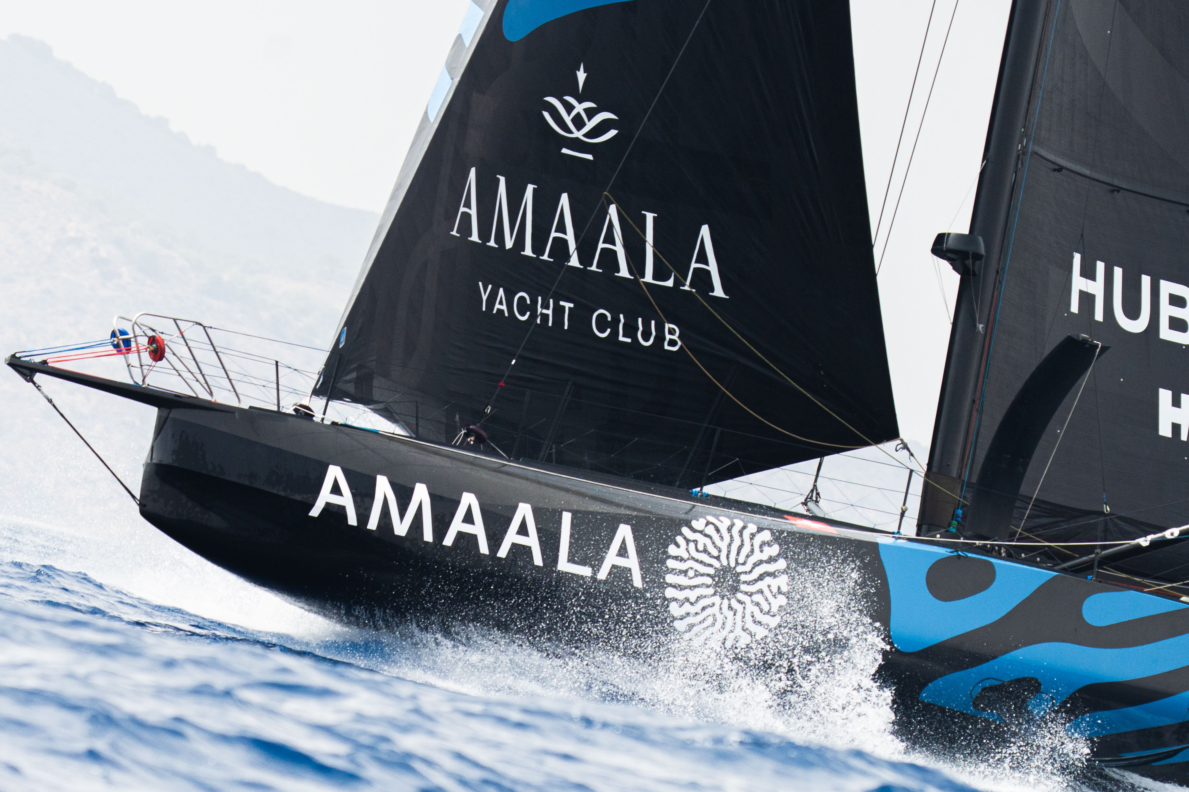 Two men wearing yellow and black face masks, standing side by side, with neutral expressions on their faces.