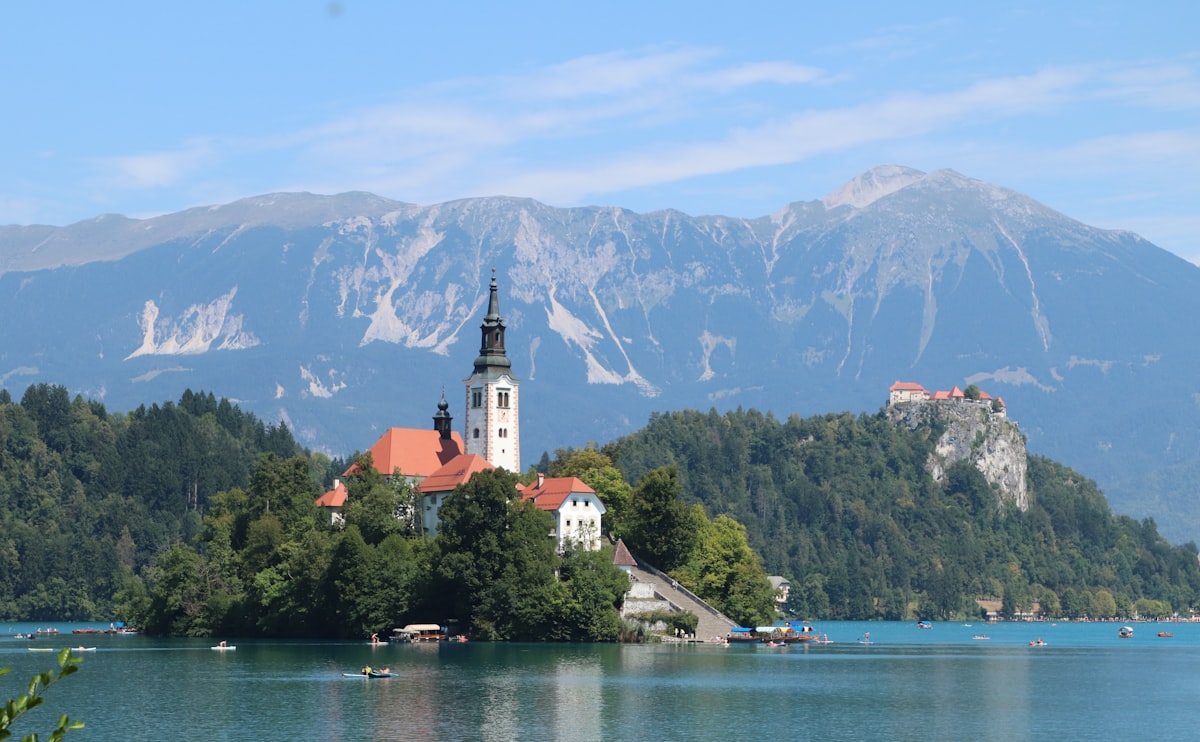 Lake Bled's island church with the Julian Alps rising behind it on a clear summer day