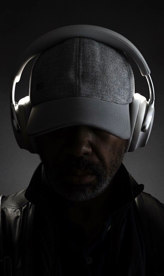 Black and white portrait of a smiling person with curly hair