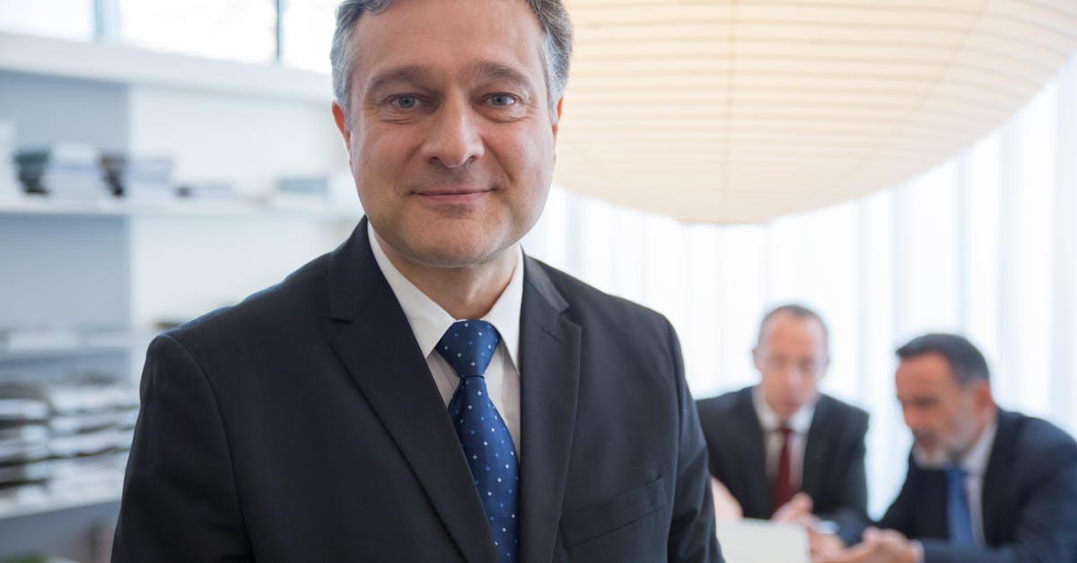 Businessman in a suit with colleagues in a modern office in Portugal.